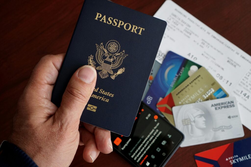 US Passport over a Smartphone Credit Cards Flight Ticket