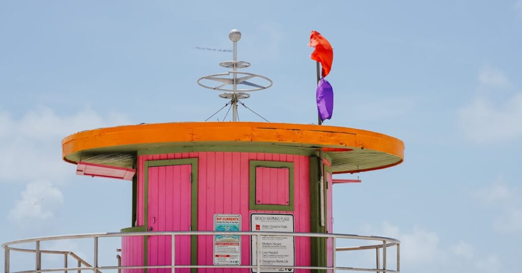 Colorful lifeguard tower on Miami Beach with people enjoying the sunny day. Ideal for travel and lifestyle themes.